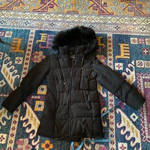 Black puffy Utex Design down jacket with hood.